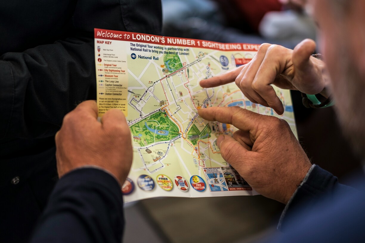 Two people planning a route together on a printed city map